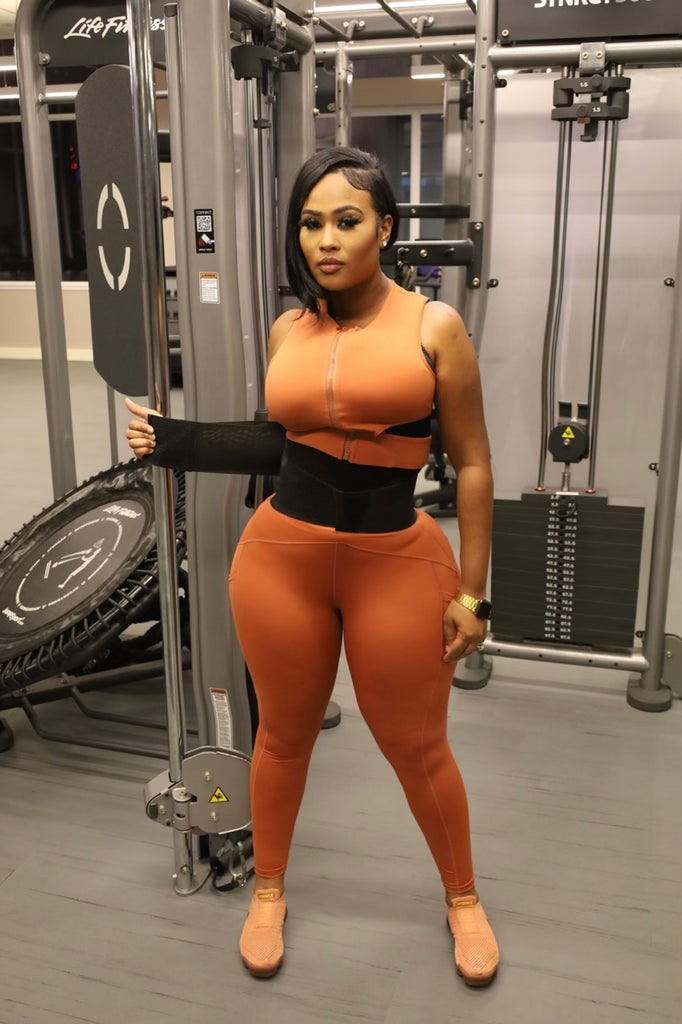 Woman in gym demonstrating waist trainer